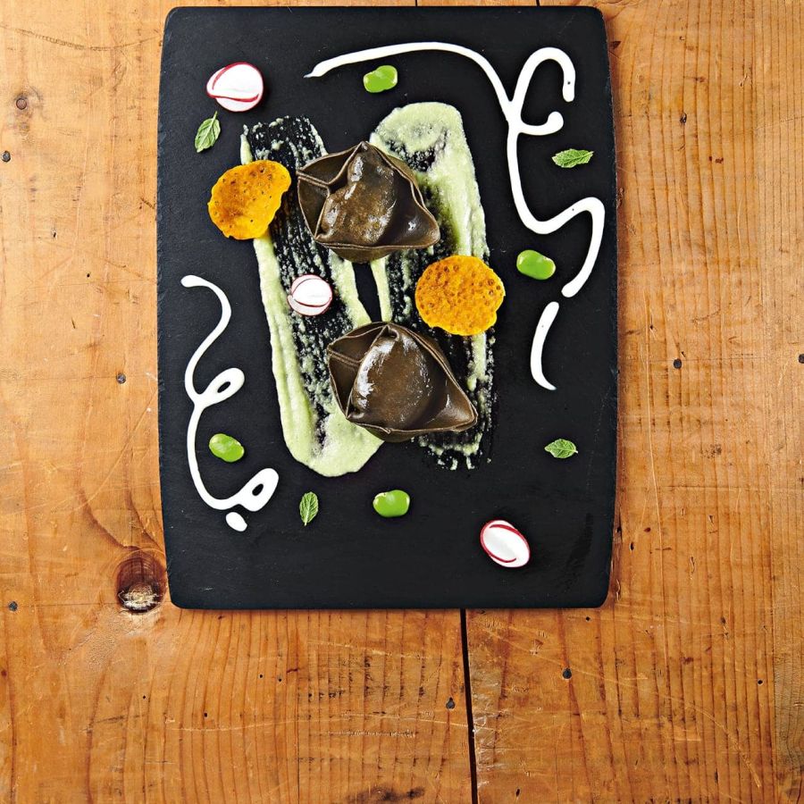 Black Giganti with salmon, fava bean cream, caciocavallo fondue, and saffron coral wafer