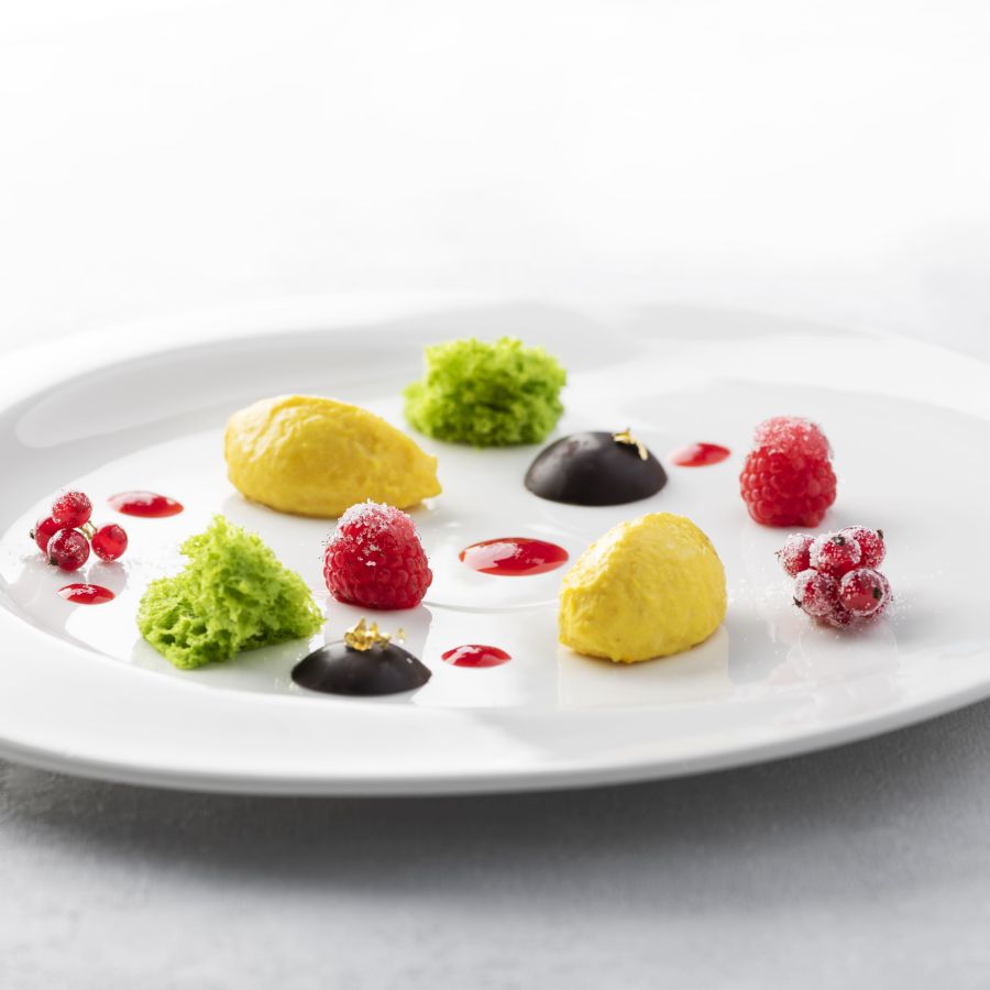 Mantecato di ricotta di bufala allo zafferano, ganache al fondente, estratto di lamponi e ribes, pan di spugna alla menta