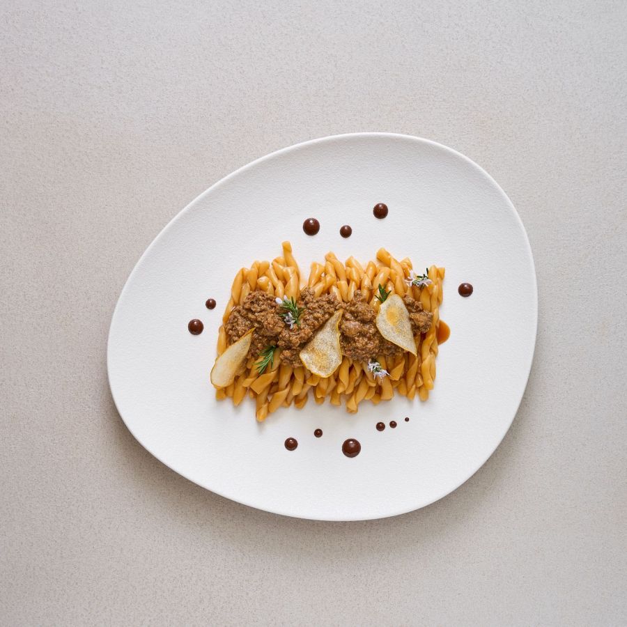 Busiate con salsa de liebre, cristales de peras con enebro y escamas de chocolate